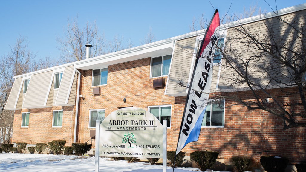 a building with a sign and a flag in the snow