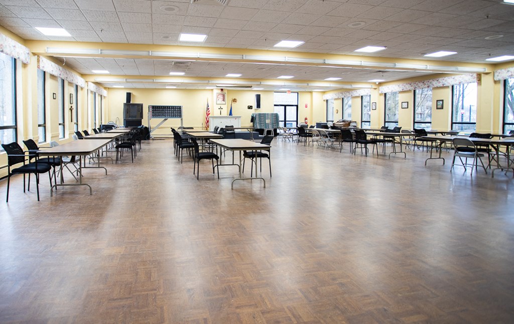 a large dining hall with tables and chairs and a dance floor