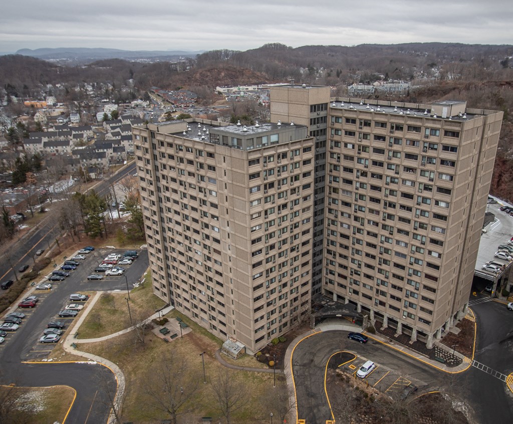 an aerial view of a tall building in a city
