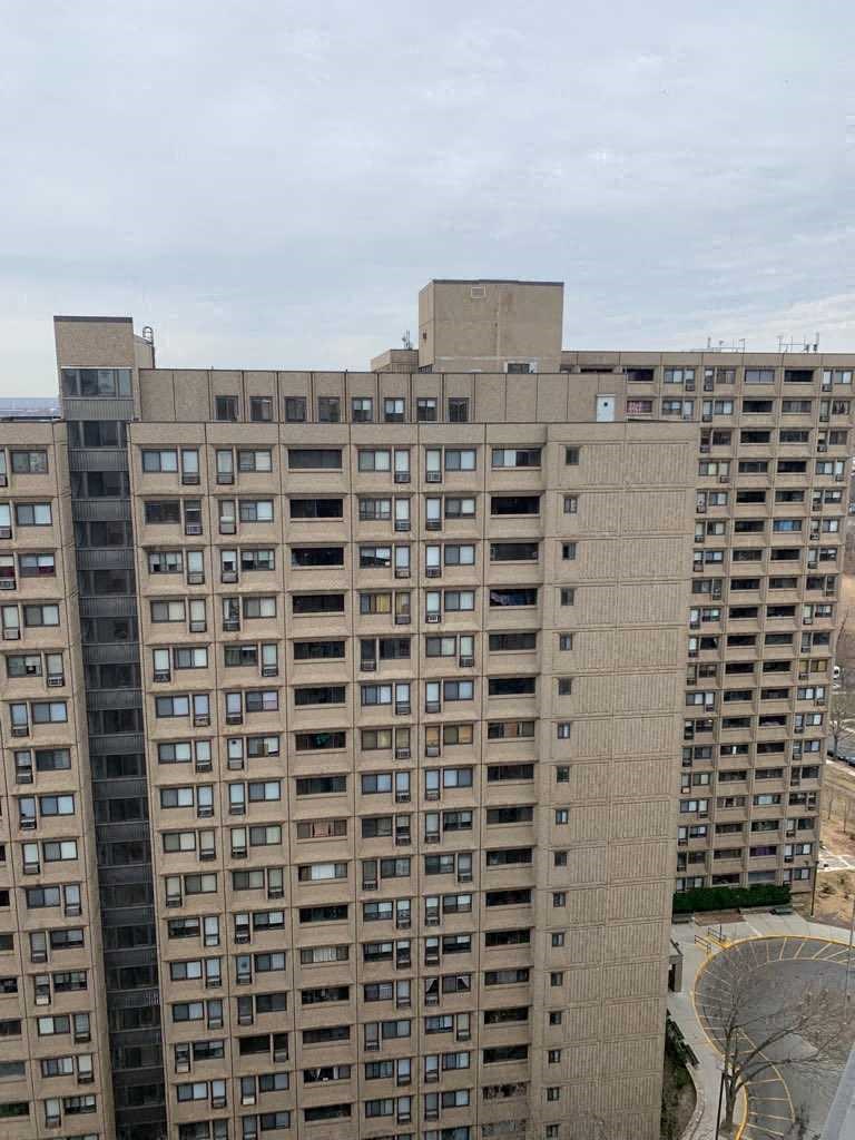 a large apartment building in a city with many windows
