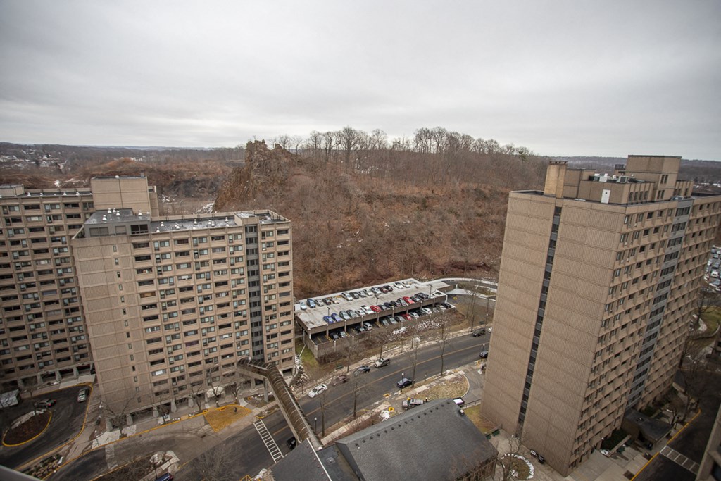 a view of a city with tall buildings and a parking lot