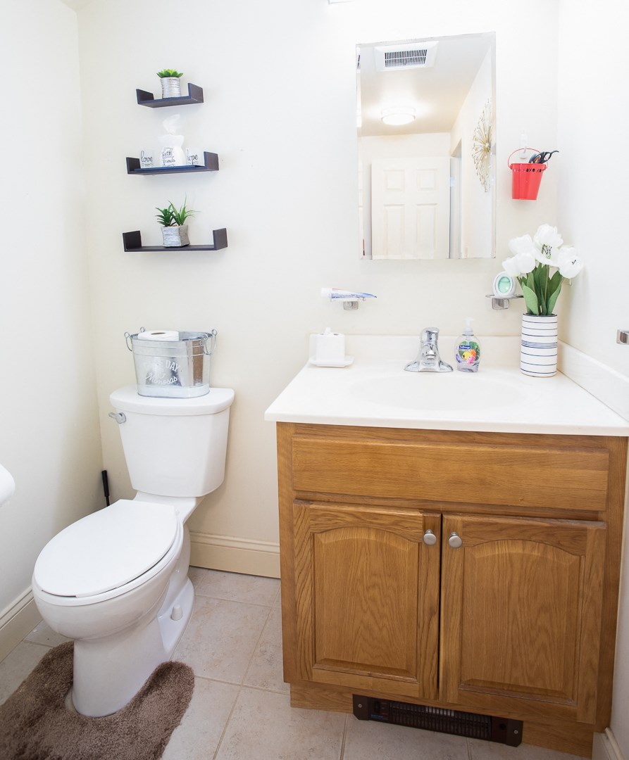 a bathroom with a toilet and a sink and a mirror
