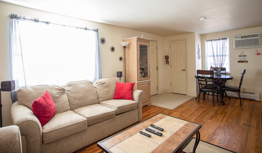 a living room and dining room with a couch and a table