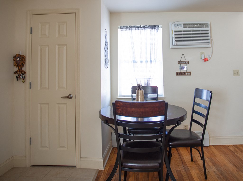 a dining room with a table and chairs and a window
