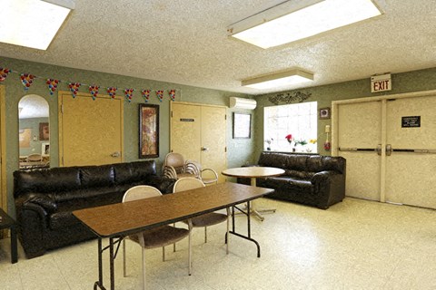 a living room with leather couches and a table and chairs