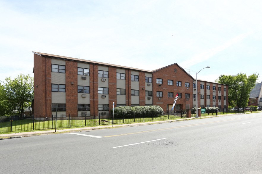 a large brick building on the side of a street
