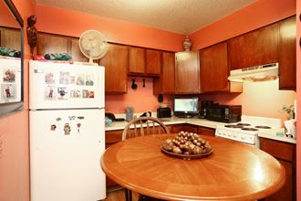 a kitchen with a table and a refrigerator
