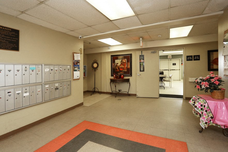 a hall with lockers and a table with a pink table cloth