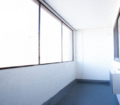 a white room with large windows and a sink