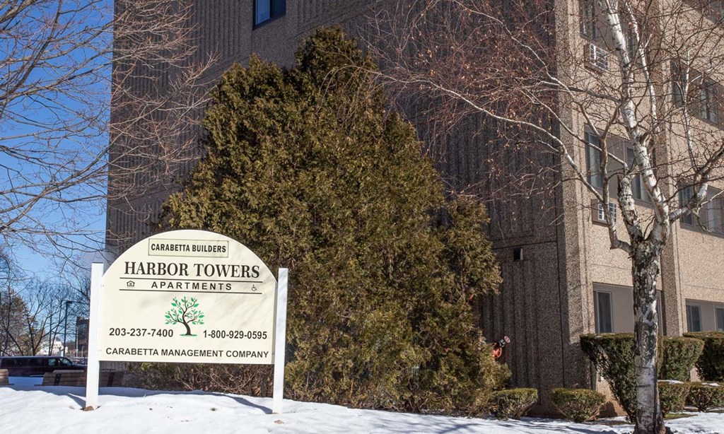 a sign in front of a building with snow