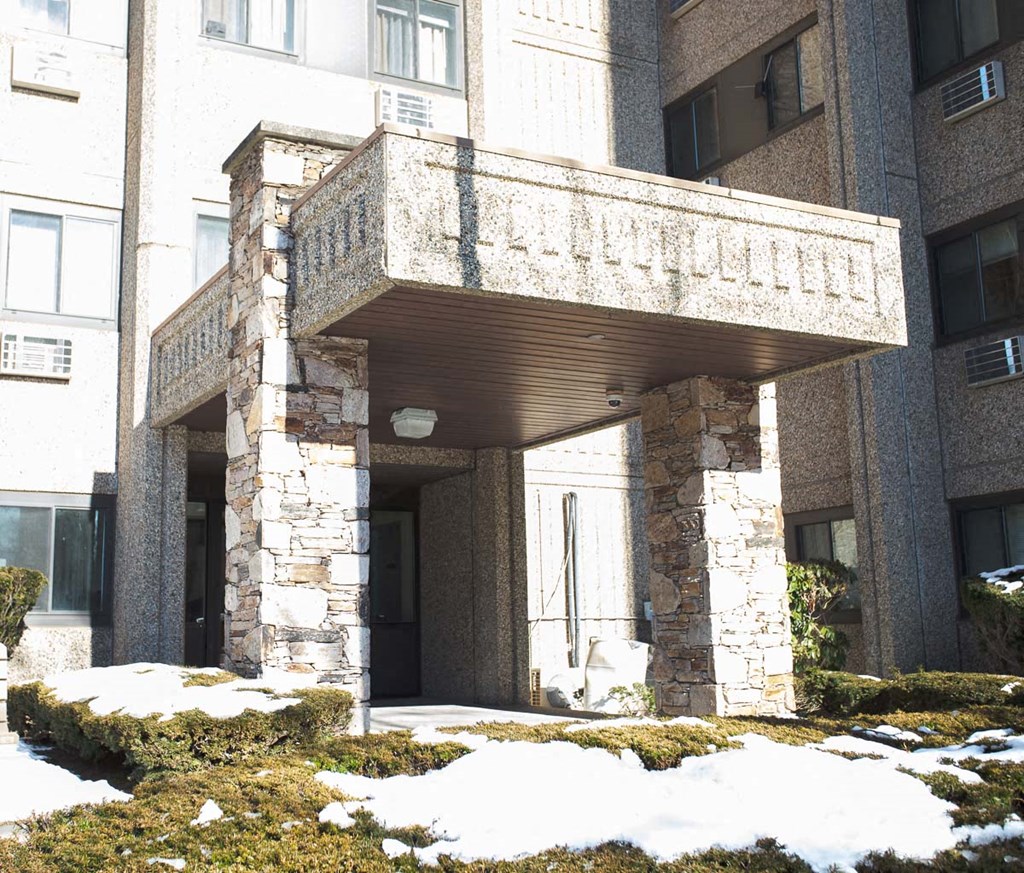 the front entrance of a building with snow on the ground