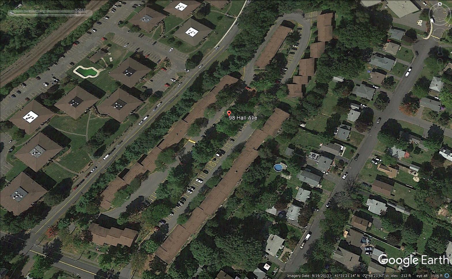 a google earth view of a neighborhood with a road and houses