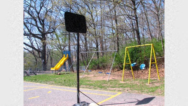 a playground with swings and a microphone in a park