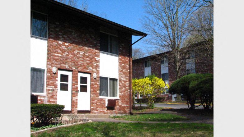 a brick building with a sidewalk in front of it