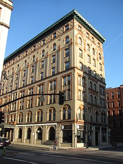 a tall building on the corner of a city street