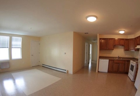 an empty living room and kitchen in a house