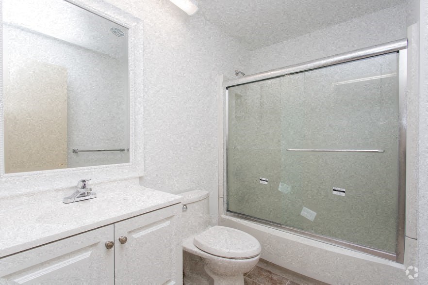 a bathroom with a sink toilet and a shower