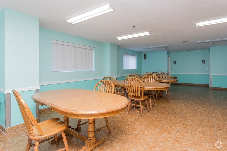 a dining room with wooden tables and chairs