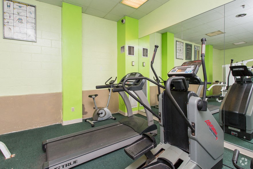 the gym is equipped with a treadmill and weights