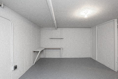 an empty room with a desk in the corner