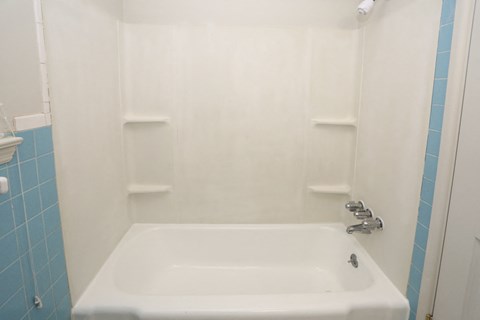 a bathroom with a white tub and a sink