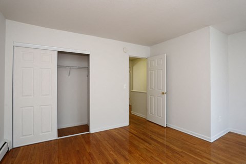a bedroom with two closets and a door to a closet