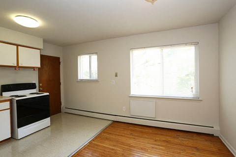 an empty kitchen with a stove and a window