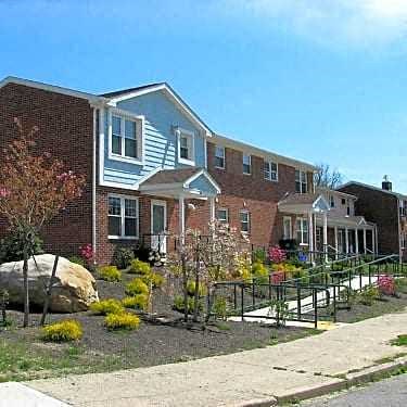 a large brick house with a garden in front of it