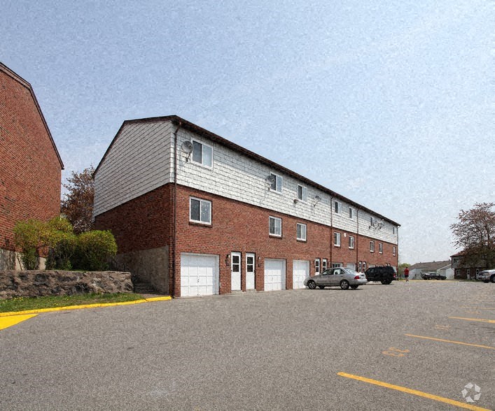 a large brick building with cars parked in front of it
