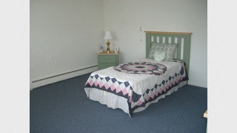 a bedroom with a bed and a night stand