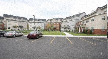 a parking lot with cars in front of some buildings