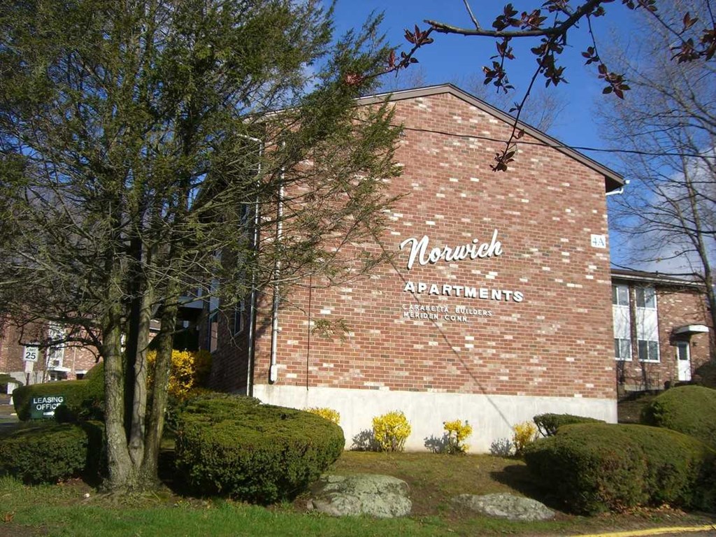 a brick building with a sign on the side of it