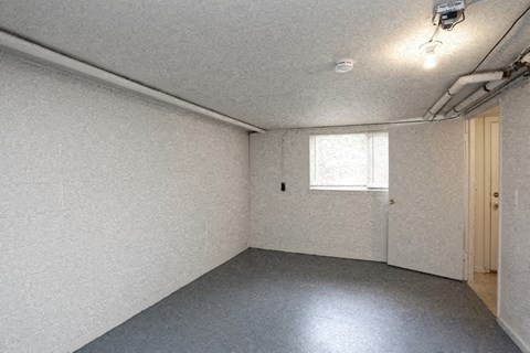 an empty room with a door and a window
