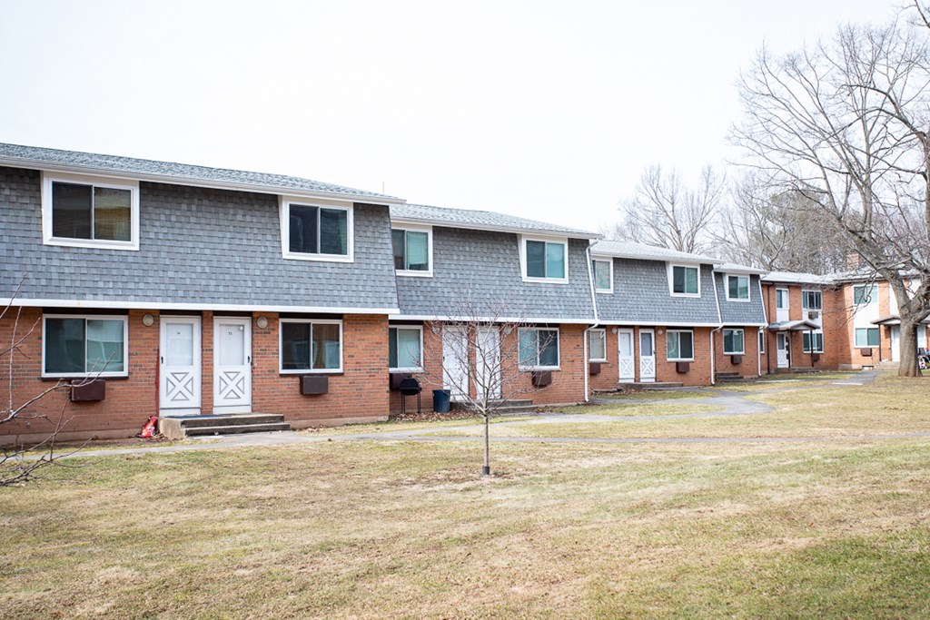 a row of houses on the side of a field