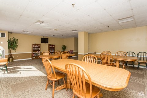 a conference room with a large wooden table and chairs