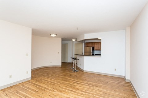 the living room and kitchen of an empty apartment