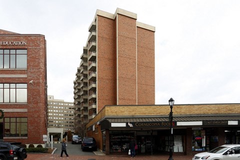 a large brick building on the corner of a city street