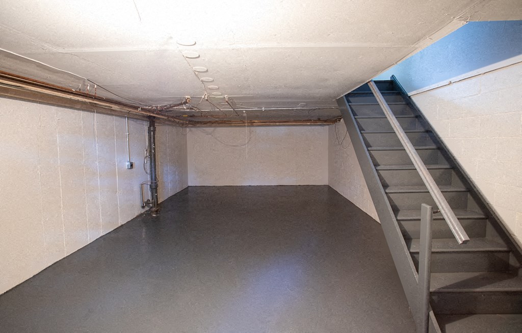 a room with a staircase and a ladder in it