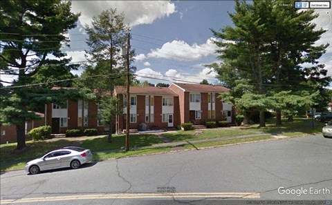a car is parked in front of an apartment building