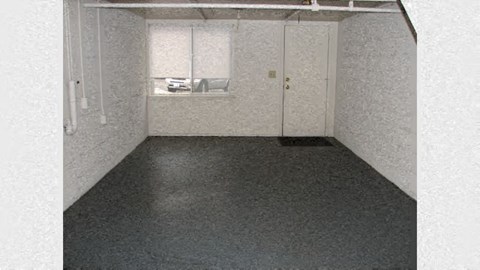 an empty room with a sink and a door