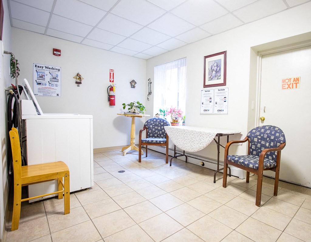 a waiting room with chairs and a table in a hospital