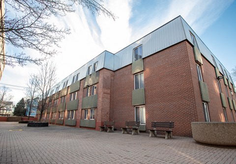 a brick building with benches in front of it