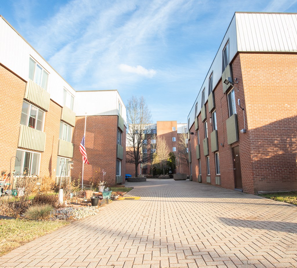 a courtyard between two buildings with an flag