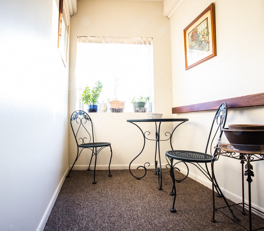 a small table and chairs in a room with a window