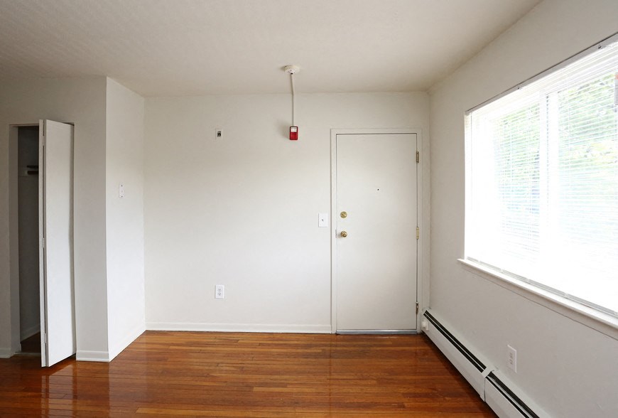 a room with a hard wood floor and a white door