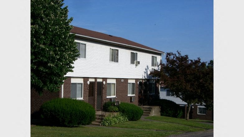 a white house with a tree in front of it