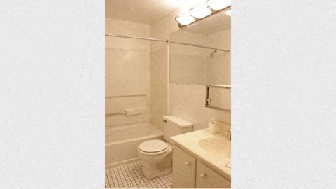 a white bathroom with a toilet and a sink