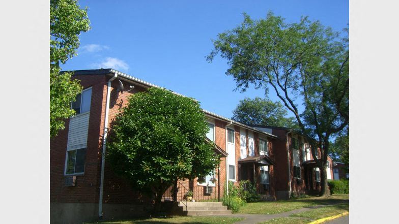 a red brick building with trees in front of it