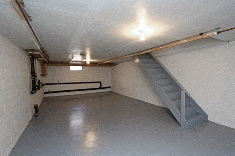 the inside of a parking garage with a staircase in the corner