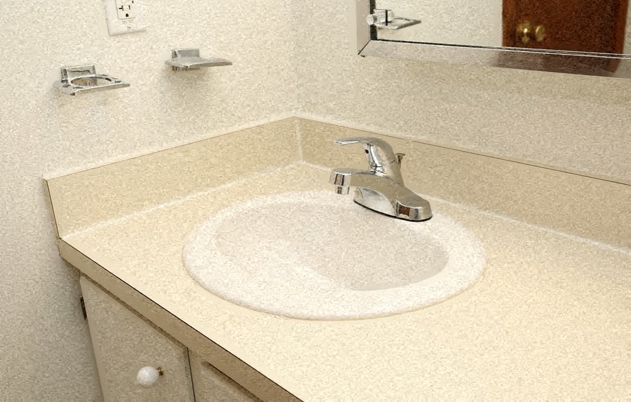 a bathroom sink with a faucet and a mirror